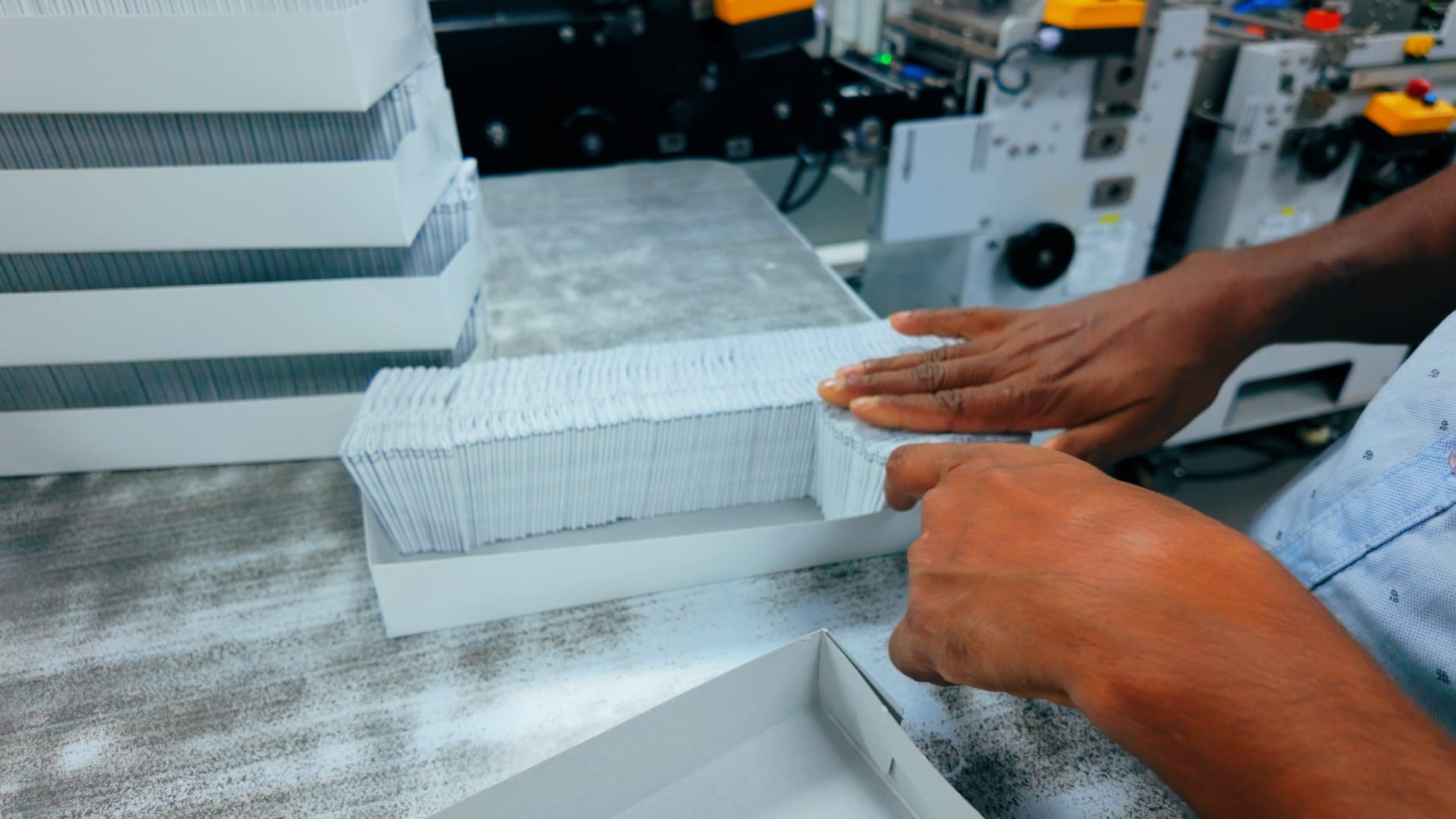 Mudrika staff hand-packing precision-folded pharmaceutical literature